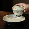 Bandeja de té de cerámica con diseño floral azul y blanco, patrón moteado rojo y forma redonda, adecuada para accesorios de ceremonia de té y uso doméstico