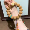 El fabricante suministra una colección de pulseras de hueso de durazno naturales, pulseras de hueso de durazno de círculo único para hombres y mujeres, populares en Xiaohongshu, con diseño de agujero pasante