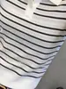 Top de punto de manga corta con cuello polo a rayas de alta gama y elegante para mujer, nuevo Top hueco adelgazante de verano 2026