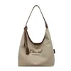 Bolso de lona simple de gran capacidad para mujer, nuevo bolso de hombro de moda 2026 con letra bordada, bolso tote casual para el día a día