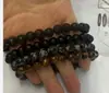 Explosiones Traje para hombre europeo y americano Moda Pulsera de piedra volcánica ojo de tigre Pulsera de copo de nieve de pino blanco Joyería Joker
