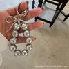Llavero Colgante Nuevo Encanto de Bolso Lazo de Perlas Coreano Mochila ins Llavero de Plata Colgante para Bolso de Coche