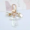 2026 Llavero de Acrílico con Lazo Iridiscente Perla Placa de Nombre Colgante Lindo Llavero para Mujer Amuletos para Bolsos
