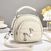 Bolsas de mujer Taizhou 2026 nuevo modelo bolsa redonda pequeña, bolso de hombro, bolso cruzado, bolso casual versátil, bolsa de manzana, venta directa de fábrica