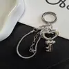 Nuevo Colgante de Llave con Lazo Plateado Fresco Corazón Hueso de Serpiente Lanyard para Teléfono Encanto para Bolso Venta al por Mayor