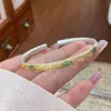 Pulsera colorida nuevo estilo chino patrón de hierba Tang pintada en oro baoxianghua para mujer esmalte color mate color apertura estilo nacional literatura y arte estilo nacional