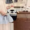 Conjunto Feminino 2026 Verão Novo Estiloso Colete de Tricô Polo Infantil e Saia Plissada Curta Conjunto de Duas Peças Tendência