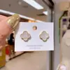 Brincos transfronteiriços de moda simples trevo de quatro folhas femininos brincos de temperamento de renda atmosfera brincos femininos joias em estoque atacado