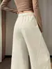 Foto real de la nueva colección de otoño 2026: pantalones de mujer de cintura alta con pierna curva y adornos de pedrería, pantalones de pierna ancha, pantalones casuales de pierna recta