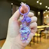 Llavero creativo de astronauta acrílico relleno de aceite, colgante de botella de arena líquida de astronauta, decoración linda, regalo pequeño al por mayor