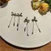 Nuevos pendientes de botón de plata S925 con forma de lazo para mujer, diseño de nicho de moda, clip para la oreja con cadena, joyería simple versátil, venta al por mayor