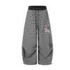 Los nuevos pantalones de chándal a rayas de estilo americano retro ligero de Magic Bear son de corte holgado, adecuados para street dance y hip-hop, con un corte curvo y diseño de pierna ancha, lo que los convierte en pantalones casuales