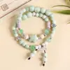 Suministro de fábrica pulsera de cerámica nueva estilo étnico retro chino pulsera elástica pulsera antigua para mujer doble círculo plegada
