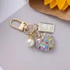 Novo chaveiro de pérola em forma de coração pingente ins fofo pequeno fresco cor quebrada pingente de bolsa para capa de fone de ouvido