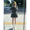 Conjunto de outfit súper popular para mujer para otoño e invierno, nuevo look universitario estilo coreano, conjunto de dos piezas de suéter de punto gris y falda