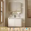 Tocador de baño engrosado y ahorrador de espacio con diseño en color crema, que cuenta con un lavabo redondeado, lavabo cerámico integrado y un lavabo de una sola pieza.