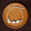 Jingdezhen Navidad Pulsera de Cuerda Trenzada de Cerámica Pulsera de Trébol de Cuatro Hojas Joyería Artística Hecha a Mano Venta al por Mayor Pulseras de Cerámica para Atracciones Turísticas