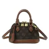 Bolso de mano para mujer transfronterizo, nuevo estilo 2026, versátil y moderno, con un patrón de monograma clásico, diseño en forma de concha, adecuado para ir al trabajo, se puede llevar como bolso de hombro o bolso cruzado