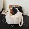 Bolso de tela casual de un hombro 2026 nueva versión coreana de gran capacidad para el trabajo cruzado bolso casual versátil para debajo del brazo para mujer