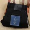 Otoño e Invierno nuevos pantalones gruesos de algodón elástico lyocell color negro oscuro para hombre, tejido anti-decoloración protección del medio ambiente, jeans de negocios para hombre