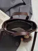 Bolso bandolera de un solo hombro casual elegante de nicho Shuai Mi Jia, moderno bolso cubo para mujer nuevo de verano 2026