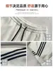 Calça Esportiva de Moletom Cinza Mescla Americana com Três Listras Feminina Outono 2026 Novo Estilo Simples Versátil Solta Afinando Calça de Pernas Largas