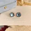 Aretes redondos simples de imitación de piedra lunar moda femenina temperamento Joker alto sentido de nicho aretes de temperamento aretes al por mayor