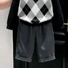 Ropa infantil coreana 2026 colección de otoño nueva: suéter clásico negro con patrón de rombos y cuello, y pantalón de traje gris recto para niños
