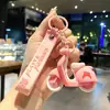 Lindo llavero de Sanrio con colgante de muñeco de dibujos animados para coche, accesorios para bolso, adornos colgantes, pequeño regalo al por mayor