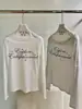 WGWE2026 Otoño Estilo Chica Caliente Americana Estampado de Letras Ajustado Ligeramente Transparente Hombros Descubiertos Manga Larga Camiseta W10842