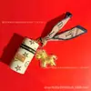 Beige Agua Oro Puro 999 Cilindro de Bendición Instantánea Llavero Colgante para Bolso de Pony Regalo Navideño para Novia Venta al por Mayor