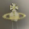 Diseño Moderno Europeo y Americano Broche de Saturno con Pedrería en Forma de Cruz Pin de Ropa para Traje de Moda Broche de Saturno para Mujer