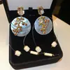 Pendientes de borla de flor de concha blanca transfronterizos europeos y americanos con perlas, pendientes de estilo de corte francés, pendientes ligeros y lujosos con un toque de alta gama