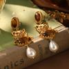 Estilo de corte europeo y americano oro ruso nicho nuevos aretes medievales borla perla diseño ojo de tigre aretes de alta gama