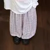 Nueva colección de otoño para niñas: un top divertido y juguetón de manga larga con estampados de dibujos animados, combinado con elegantes y versátiles pantalones de cuadros de pierna ancha