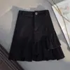 Falda corta 2026 primavera-verano nuevo estilo mezclilla blanca volantes irregulares falda de línea A de cintura alta falda anti-exposición para mujer