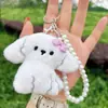 Lindo peluche con moño, llavero de cachorro, abalorios de perlas de alta gama, colgante de charm girly estilo Ins