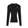 Camiseta básica de cuello medio alto negra para mujer, nuevo estilo otoño 2026, suéter de punto interior sexy y elegante con diseño hueco de alta gama