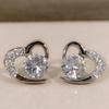 Brincos de tarracha de coração de pêssego em prata de lei com diamante Super Flash brincos de tarracha dinâmicos em forma de coração brincos de zircônia em forma de coração bonitos e simétricos