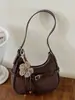 Bolsa versátil estilo moda coreana transfronteiriça para trabalho, modelo novo de nicho outono 2026, bolsa de mão feminina, bolsa de ombro e crossbody estilo bolinho