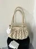 Bolso de hombro y axila con diseño único de lunares plisados para mujer, nuevo bolso de moda de verano 2026 de doble uso para el trabajo y los desplazamientos