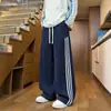 Pantalones casuales deportivos a rayas estilo americano patchwork color contrastante sueltos de pierna recta pantalones de pierna ancha pantalones de chándal de otoño para hombre