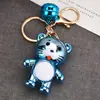 Nuevo Llavero de Tigre Pequeño MengMeng de Acrílico Accesorios de Campana de Colores Colgante para Mochila Escolar de Estudiante Pequeños Accesorios para Llaves
