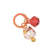 Clip de resorte Campanita Llavero de Gato Dibujo animado lindo Gato Donut Mochila Funda para auriculares Colgante de moda versátil