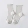 Calcetines sin estampado sin calcetines de color liso estándar otoño e invierno calcetines de algodón de colores dulces calcetines para mujer calcetines para el suelo venta al por mayor directa de fábrica
