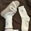 Calcetines de felpa para mujer, estilo coreano, de media pantorrilla, cálidos de invierno, forrados de forro polar, gruesos, blancos, con lazo, calcetines holgados de moda de media pantorrilla