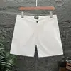 Pantalones cortos casuales para hombre, pantalones de tres cuartos y cuatro cuartos de color liso ajustados a la moda, pantalones cortos negros ultracortos elásticos de marca de moda de verano