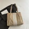 Bolso tote de lona de gran capacidad estilo casual coreano 2026 para mujer, nuevo bolso de mano de moda para estudiantes, adecuado para la escuela y el trabajo