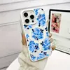 Funda magnética para teléfono Apple 17Promax Dos en uno para iPhone 15 Flor azul Agujero grande Funda protectora