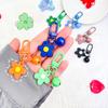Ins fresco colorido pequena flor Bell chaveiro diy pingente feito à mão menina saco do coração porta fivela ornamentos bonitos